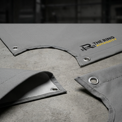 Gray fabric with grommets and 'The Ring Authority' logo on a concrete surface.